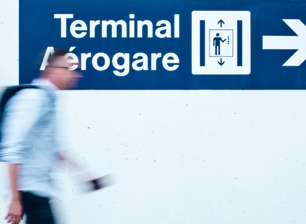 Man walks into an airport with passport in hand