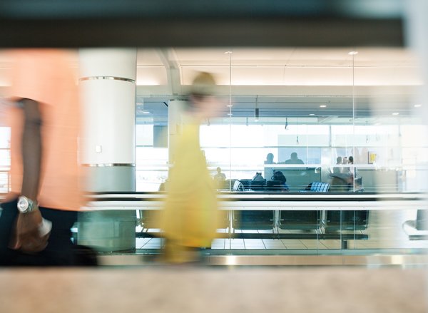 Man walks across moving walkway in airport